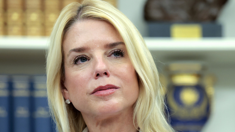 Pam Bondi with curled eyelashes and pink lipstick