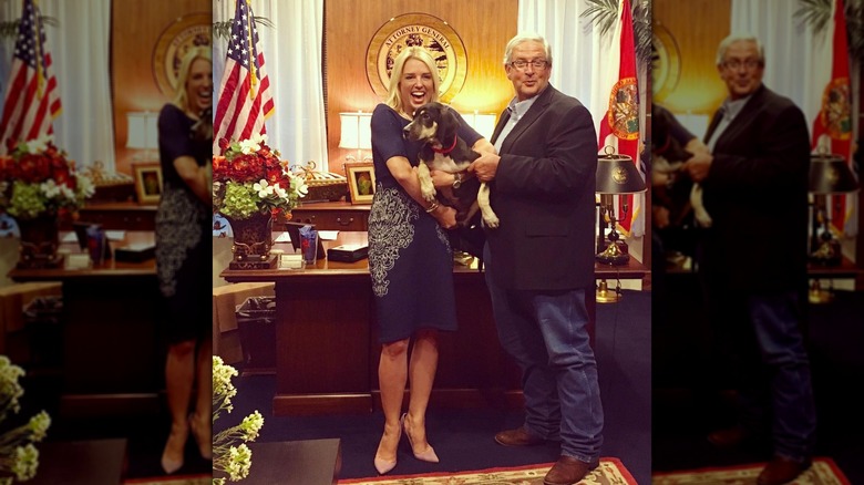 Pam Bondi holding a dog in her office