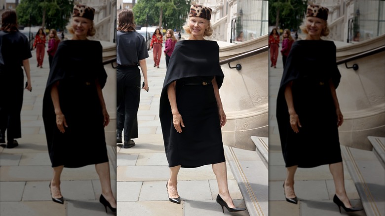Pamela Anderson in a black cape dress with a hat