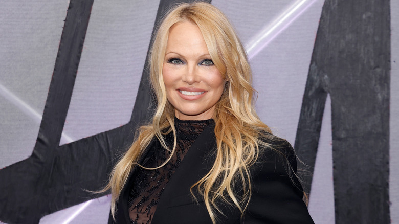 Pamela Anderson smiles on the red carpet in 2023