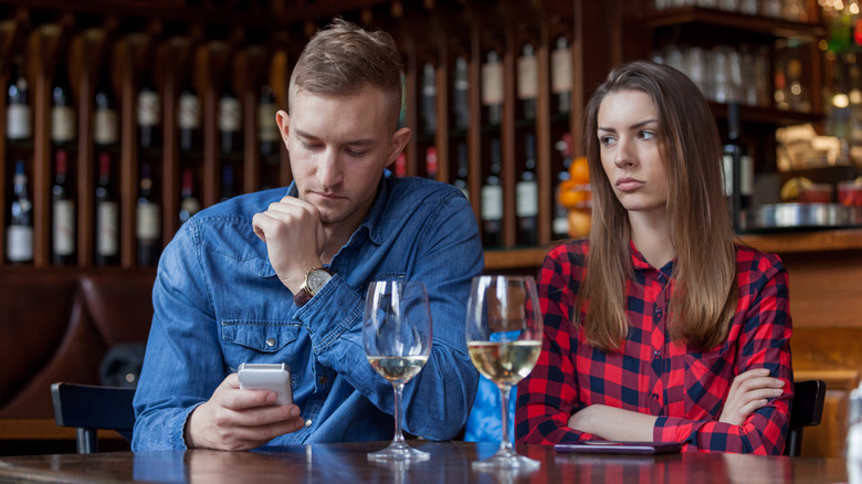 Woman with with man who's phubbing