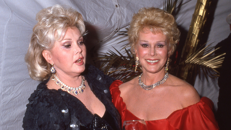 Zsa Zsa Gabor (L) and Eva Gabor (R) wearing a crystal necklaces and diamond earrings