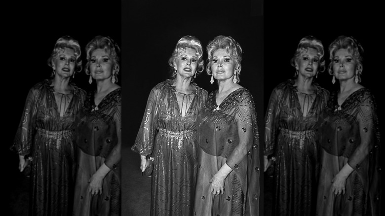 Eva Gabor (L) wearing a caftan-style dress next to Zsa Zsa Gabor (R) wearing an embellished sheer gown
