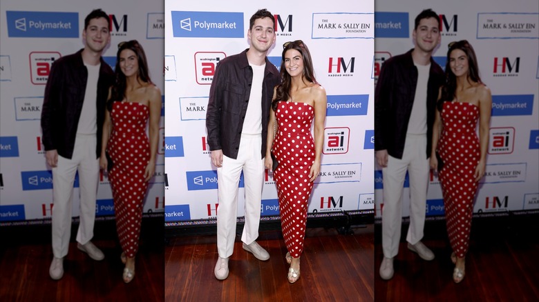 Kaitlan Collins smiles next to Matt Friend wearing a red polka dot dress