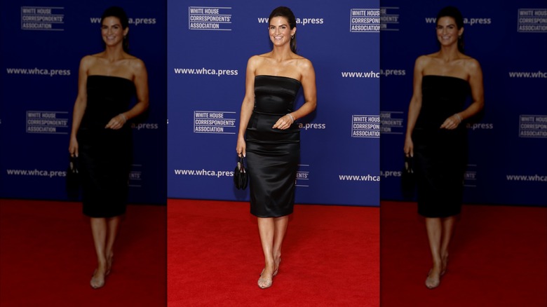 Kaitlan Collins wears her hair up and smiles wearing a black satin bandeau dress
