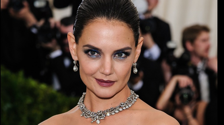 Katie Holmes wearing a slick back bun and smoky eye makeup