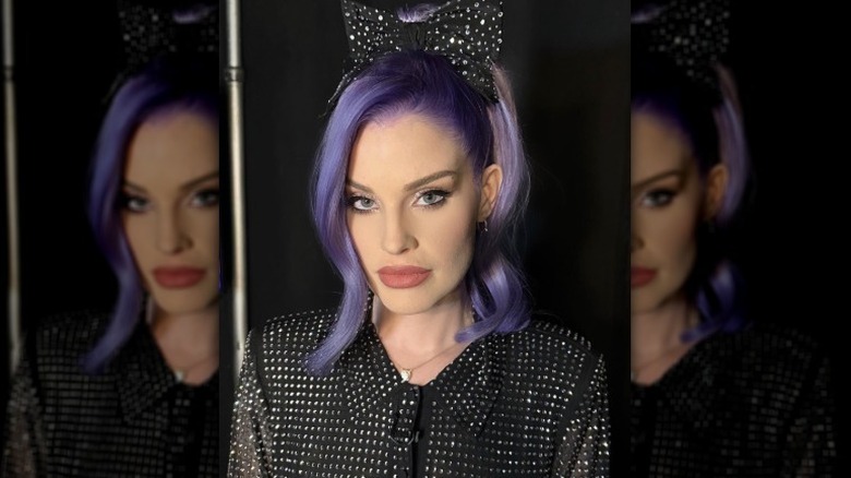 Kelly Osbourne poses with purple hair