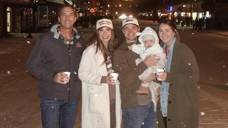 Bryon Noem and Kristi Noem posing with their daughter and her family in the snow