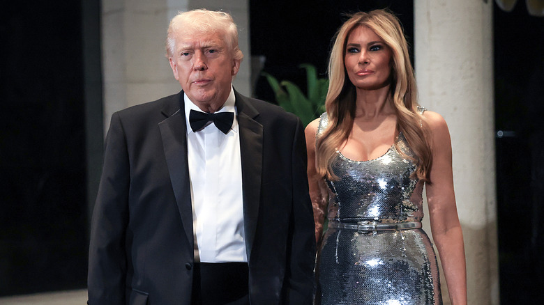 Donald Trump and first lady Melania Trump arrive for a New Year's Eve event at his Mar-a-Lago home on December 31, 2025 in Palm Beach, Florida