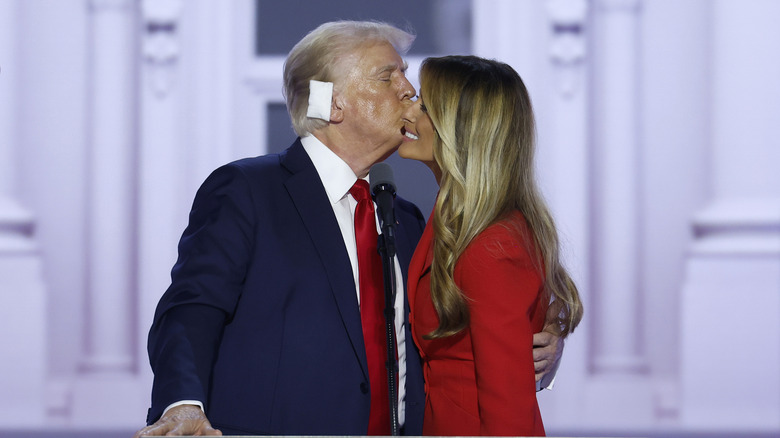 Donald Trump kisses former first lady Melania Trump after officially accepting the Republican presidential nomination on stage on the fourth day of the Republican National Convention at the Fiserv Forum on July 18, 2024