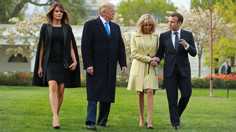 Melania Trump, U.S President Donald Trump, Brigitte Macron and French President Emmanuel Macron walk across the South Lawn before participating in a tree-planting ceremony at the White House April 23, 2018