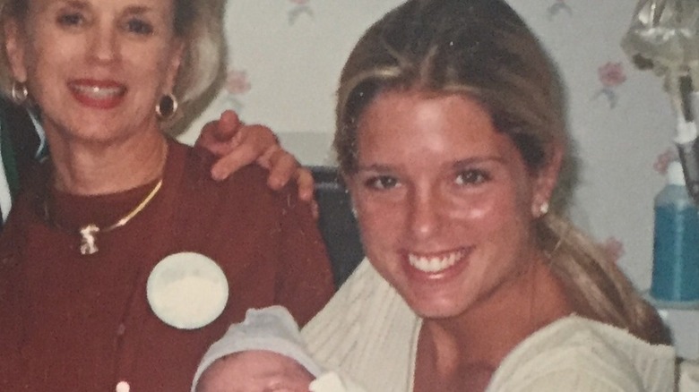 Pam Bondi in her 30s holding a baby
