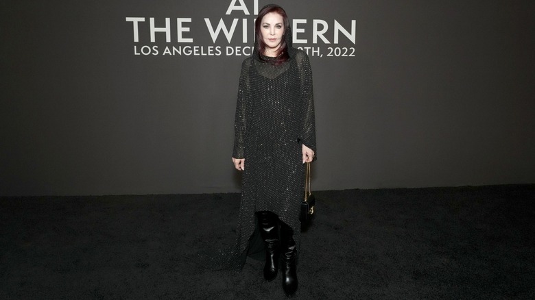 Priscilla Presley wearing a hooded, sparkle-dotted dress for a fashion event