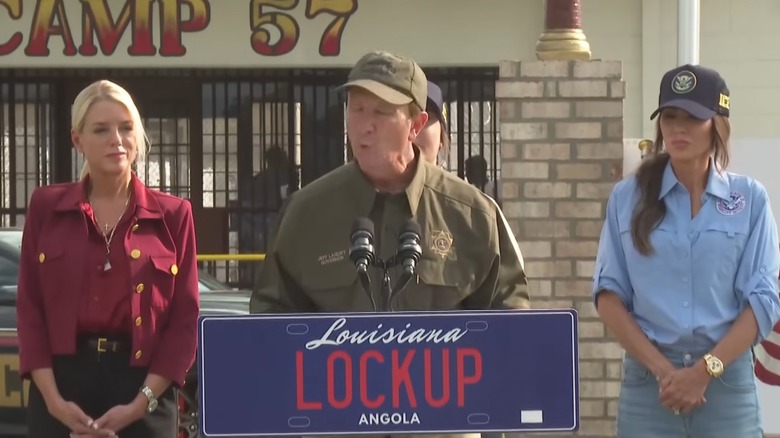 Pam Bondi and Kristi Noem with a gentleman at a press briefing