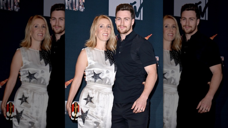 Sam Taylor-Johnson wears a starry dress next to Aaron Taylor-Johnson in a black outfit