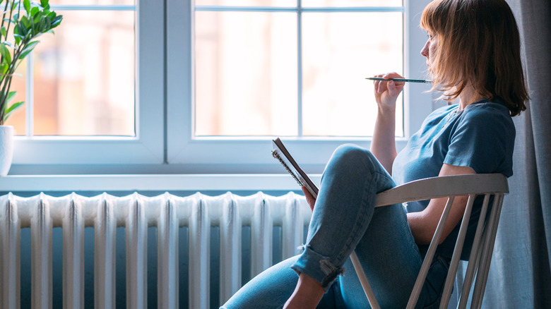 Thoughtful woman journaling