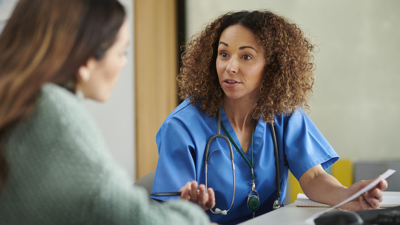 Woman discusses health with a medical professional 