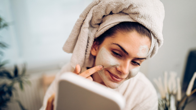 Woman applying face mask
