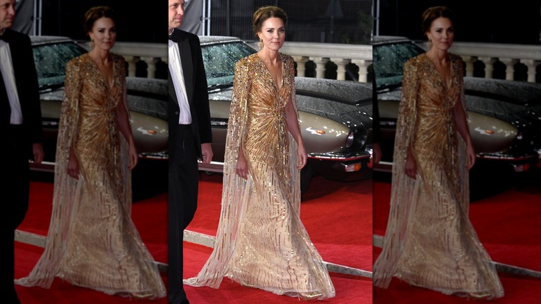 Kate Middleton walking at the premiere of "No Time to Die" in a sparkly, gold gown