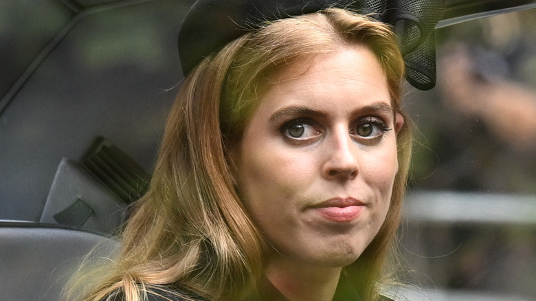Princess Beatrice looks out a car window in 2022