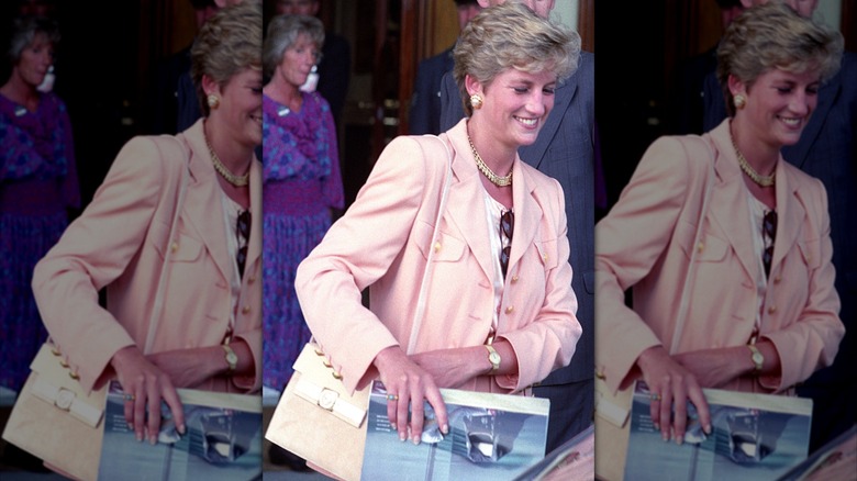 Princess Diana walking and wearing a peach colored suit jacket