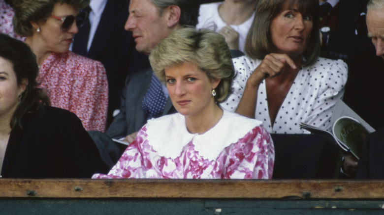 Princess Diana in the stands at Wimbledon wearing a pink floral dress