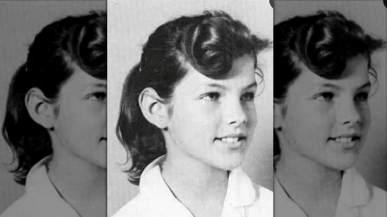 A black-and-white photo of a young Priscilla Presley wearing a ponytail with a large curl over her forehead
