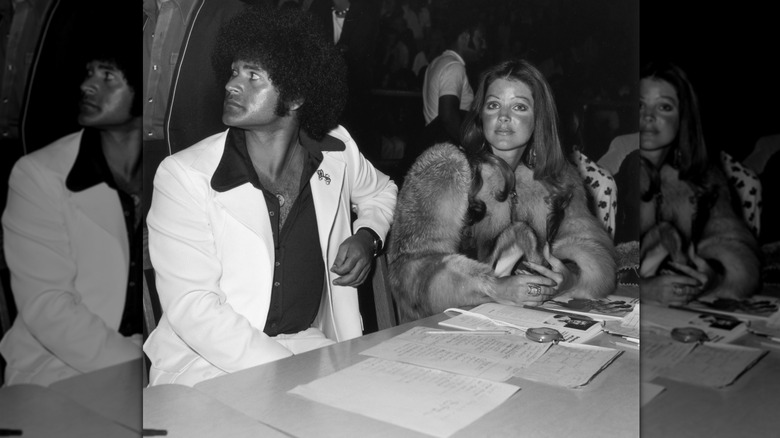 American actor Priscilla Presley sits with her boyfriend, karate instructor Mike Stone, at a kung fu tournament