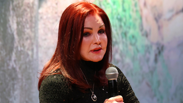 Priscilla Presley speaking into a microphone