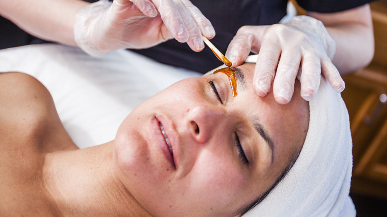 African American woman applying face cream