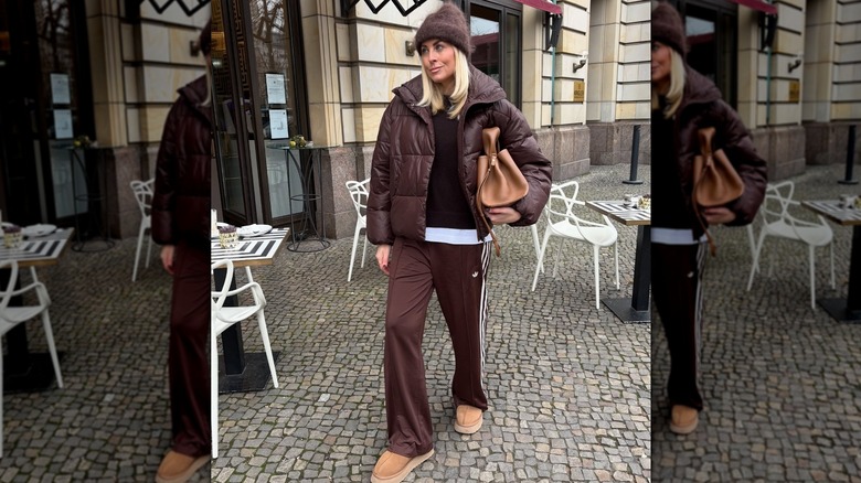 A woman in a monochrome brown puffer coat look