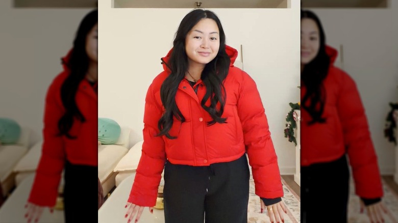 A woman in a red puffer coat