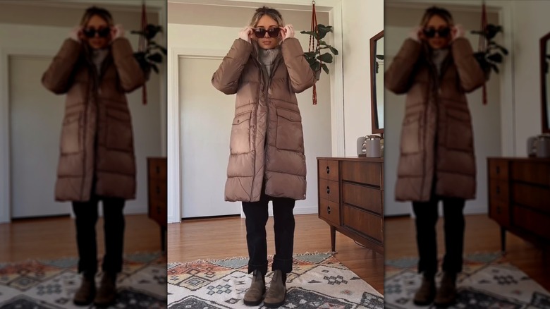 A woman in a brown puffer coat