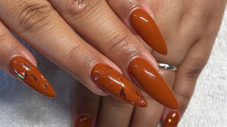Orange nails with holographic nail art