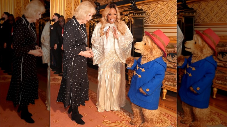 Queen Camilla greets Paddington Bear and Marisha Wallace during a reception at the final of BBC's creative writing competition 500 Words at Windsor Castle on February 25, 2026