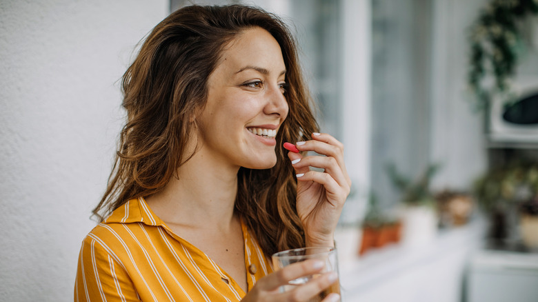 Woman taking vitamin