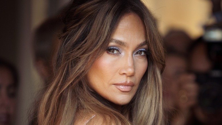 Jennifer Lopez posing over her shoulder with a neutral expression