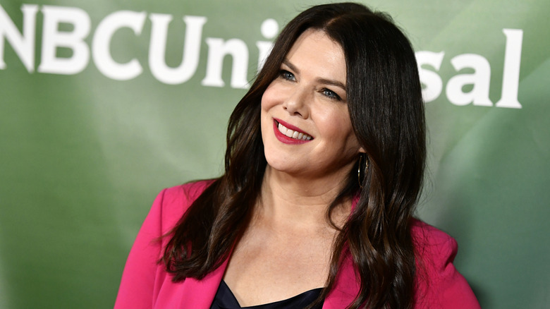 Lauren graham smiling while wearing a pink blazer and dark top at the 2020 NBCUniversal Winter Press Tour