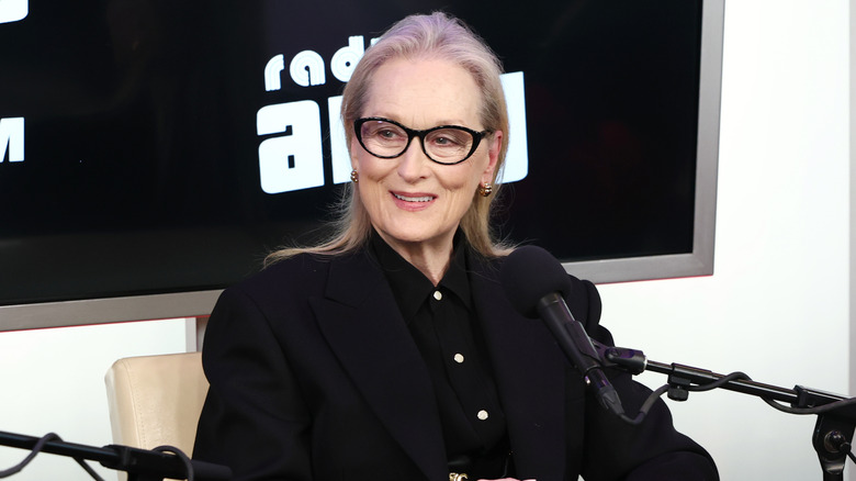 Meryl Streep sitting in front of a microphone