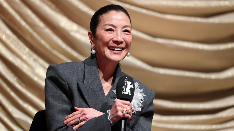 Michelle Yeoh smiling and speaking at the 