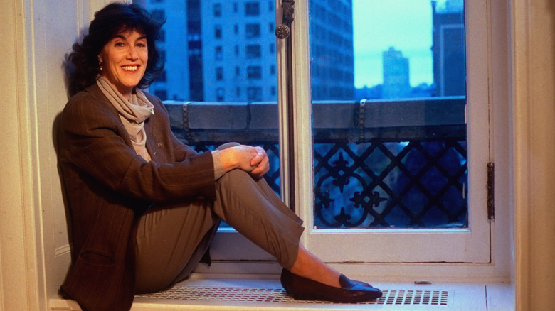 Nora Ephron sitting in her windowsill in New York City