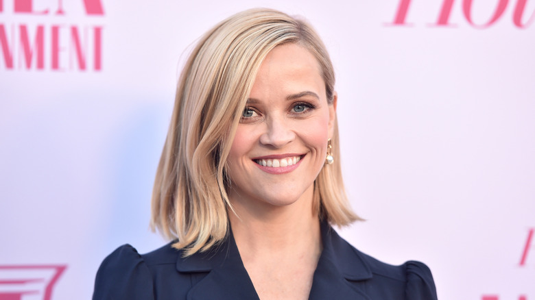 Reese Witherspoon in a navy blazer with a short haircut
