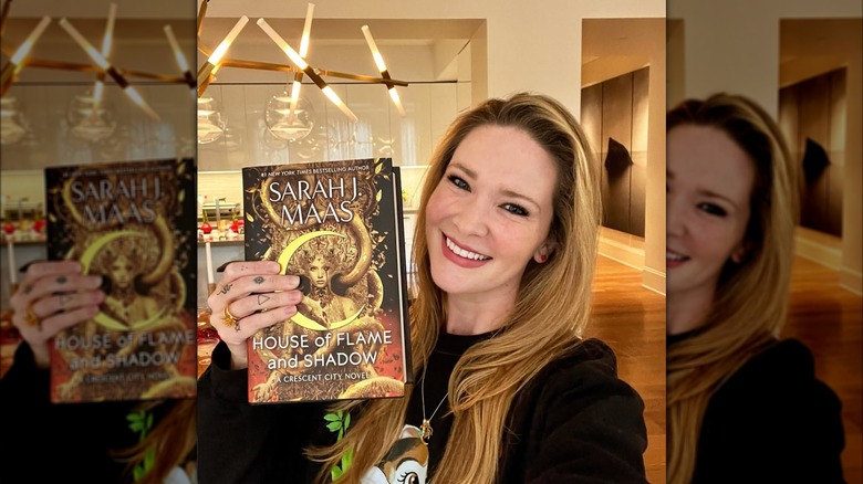 Sarah J. Maas taking a selfie with her new book on Instagram