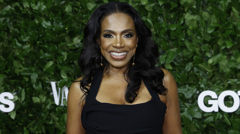 Sheryl Lee Ralph smiling while posing in front of a hedge background at the Gotham Awards