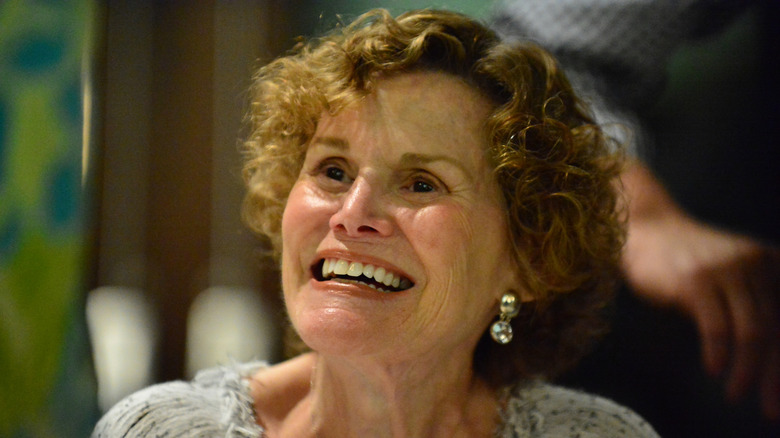 A close-up of Judy Blume looking up and smiling
