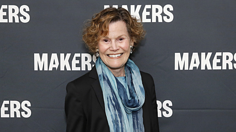 Judy Blume wearing a blue scarf and a black blazer at an event