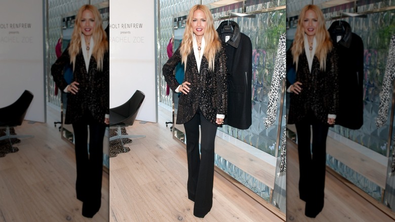 Rachel Zoe wearing a black blazer, bell trousers and a white shirt