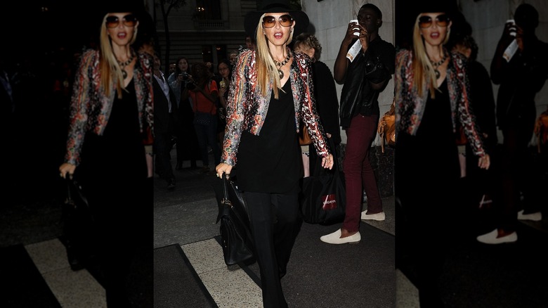Rachel Zoe wearing a patterned blazer, large sunglasses and an all black outfit