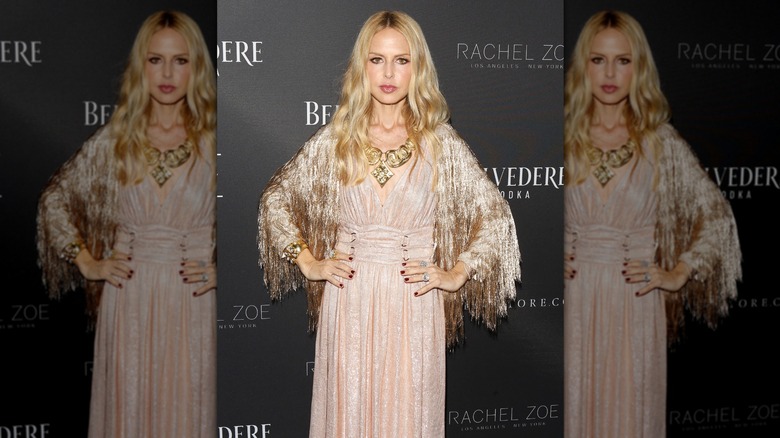 Rachel Zoe in pale layered gown with fringe cardigan