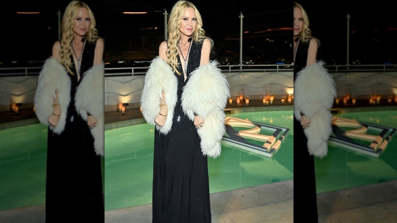 Rachel Zoe in black dress white fur stole